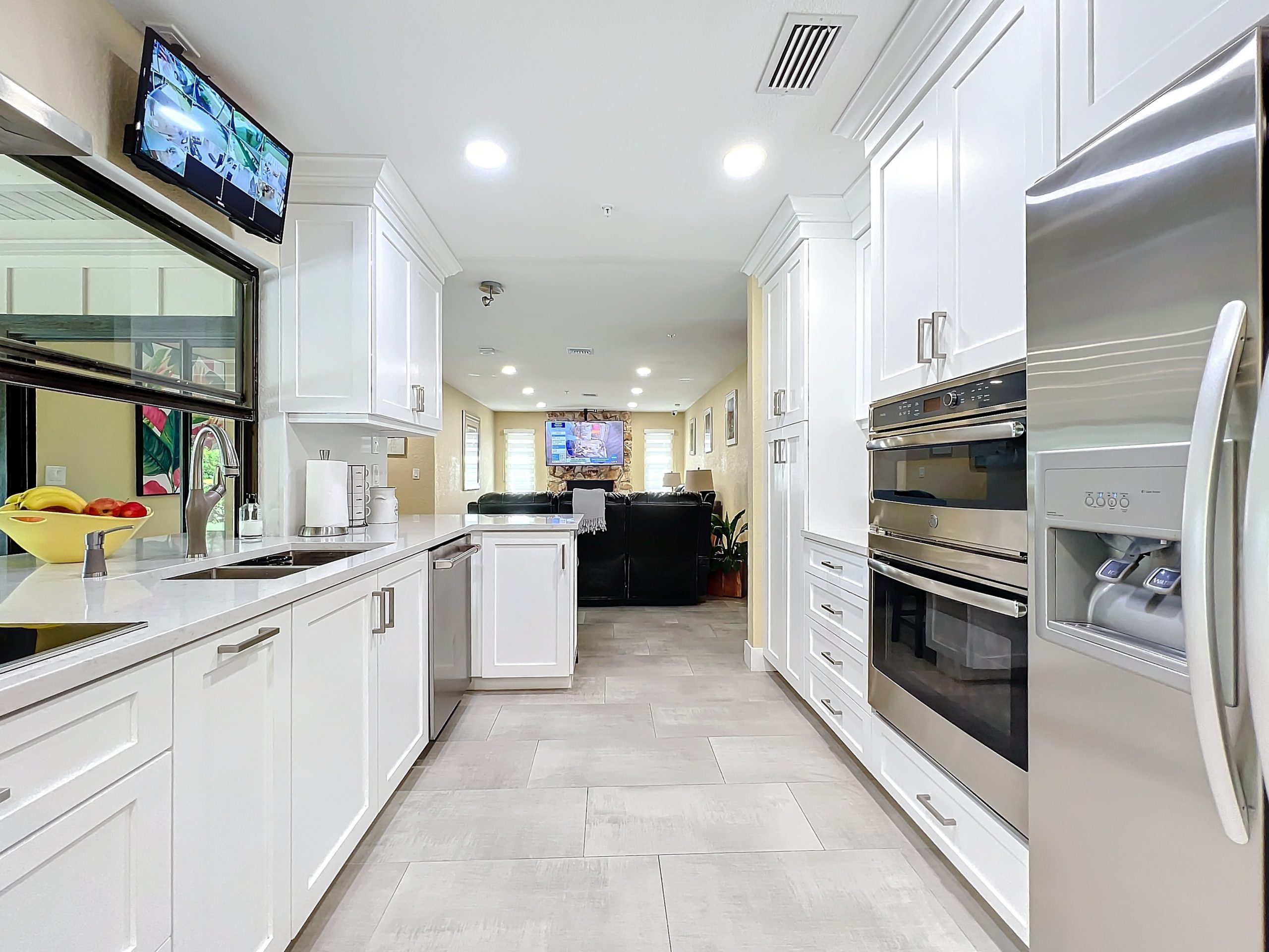 Modern gourmet kitchen with premium stainless steel appliances and white cabinetry at Abundant Care Residence in Wellington, FL