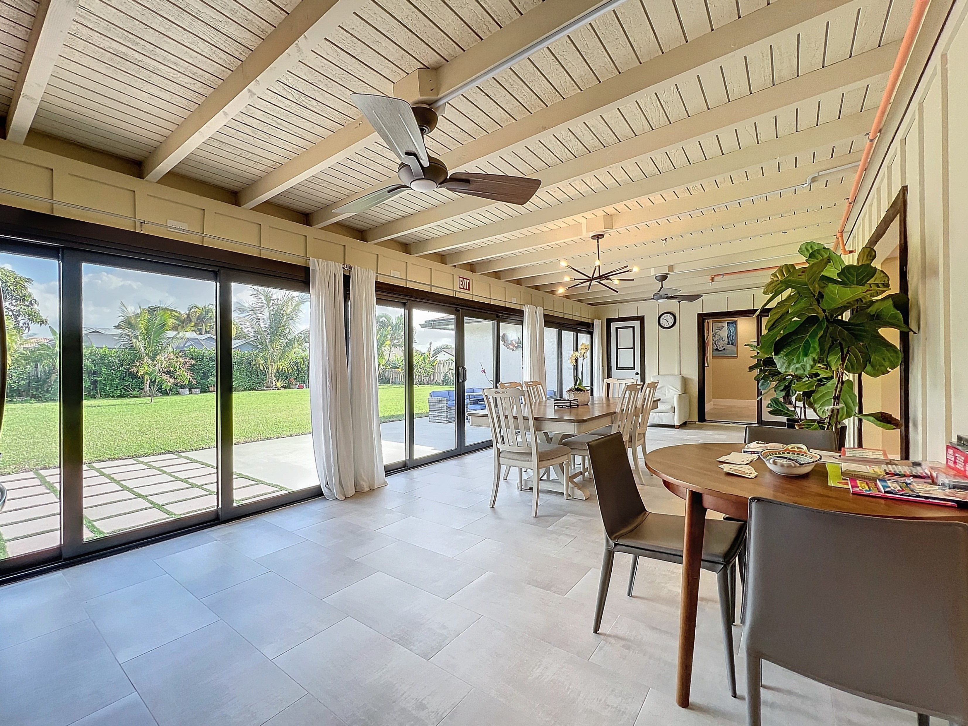 Spacious indoor-outdoor sunroom and dining area at Abundant Care Residence in Wellington FL